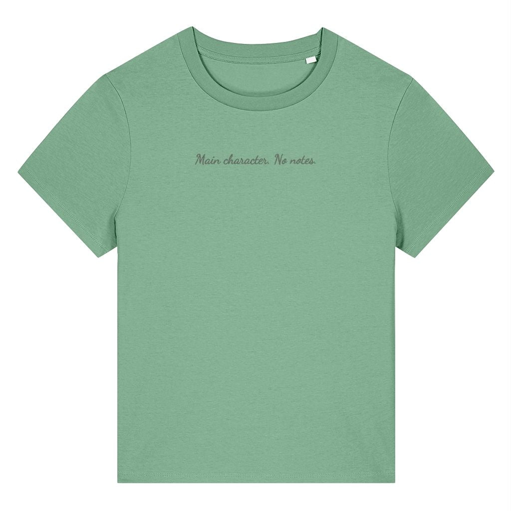 Green organic cotton women's t-shirt featuring the confidence quote ‘Main Character. No Notes.’ by Rivaex Clothing