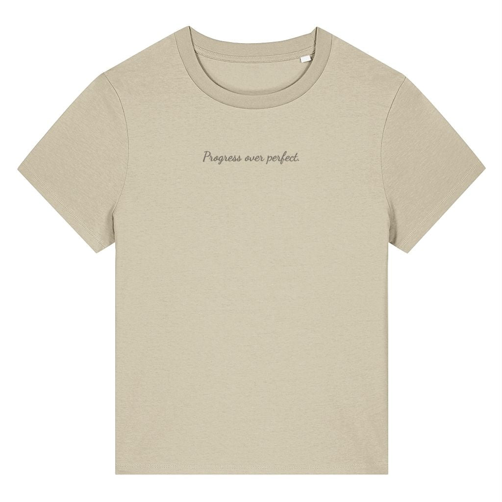 Beige organic cotton women's t-shirt featuring the motivational quote ‘Progress Over Perfect.’ by Rivaex Clothing
