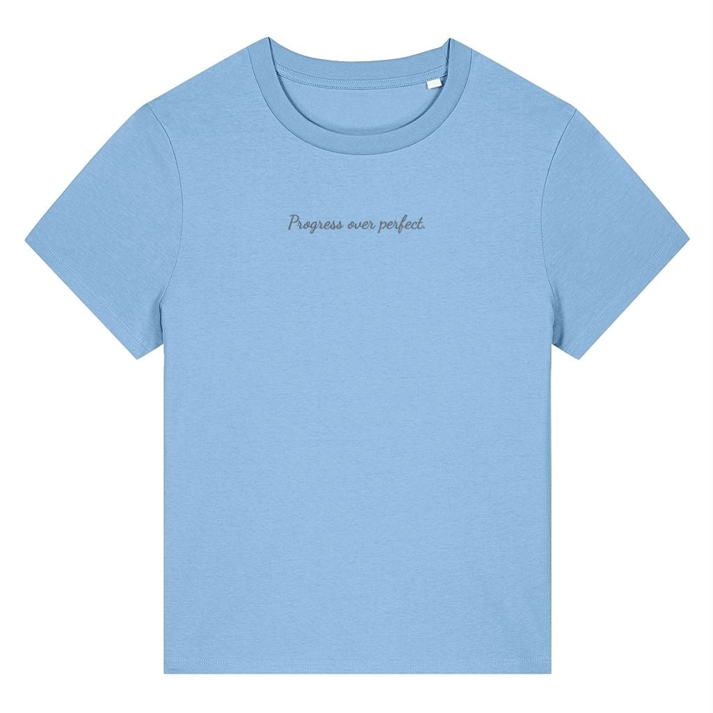 Light blue organic cotton women's t-shirt featuring the motivational quote ‘Progress Over Perfect.’ by Rivaex Clothing